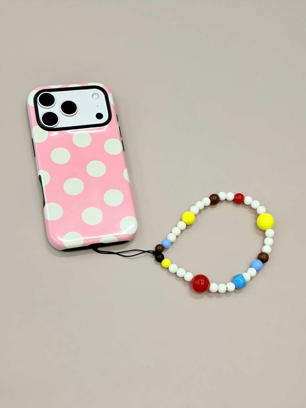 Beaded phone strap attached to mobile phone case