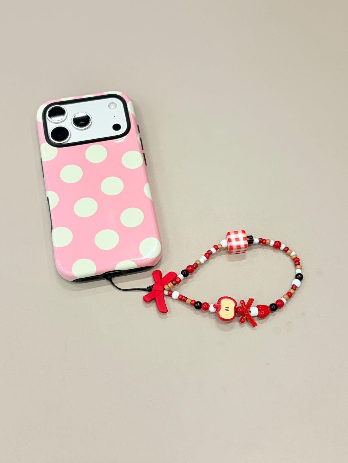 Bow beaded phone strap attached to mobile phone case