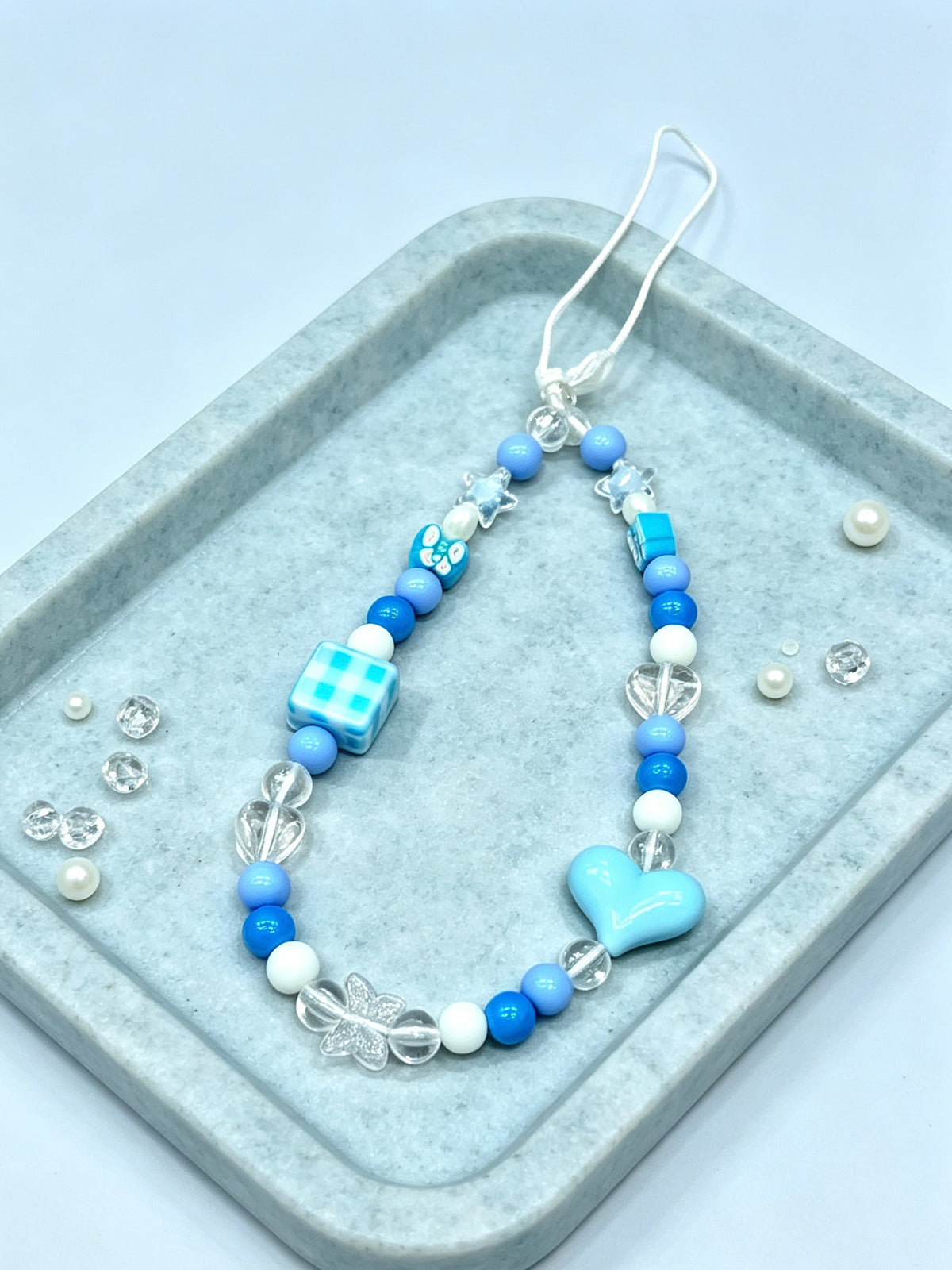 Close-up detail of heart bead phone strap accessory