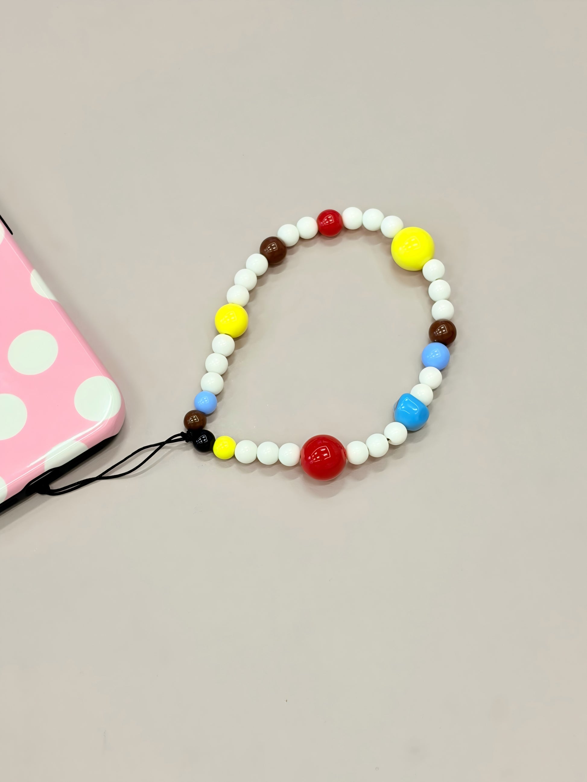 Beaded phone strap with handmade decorative design