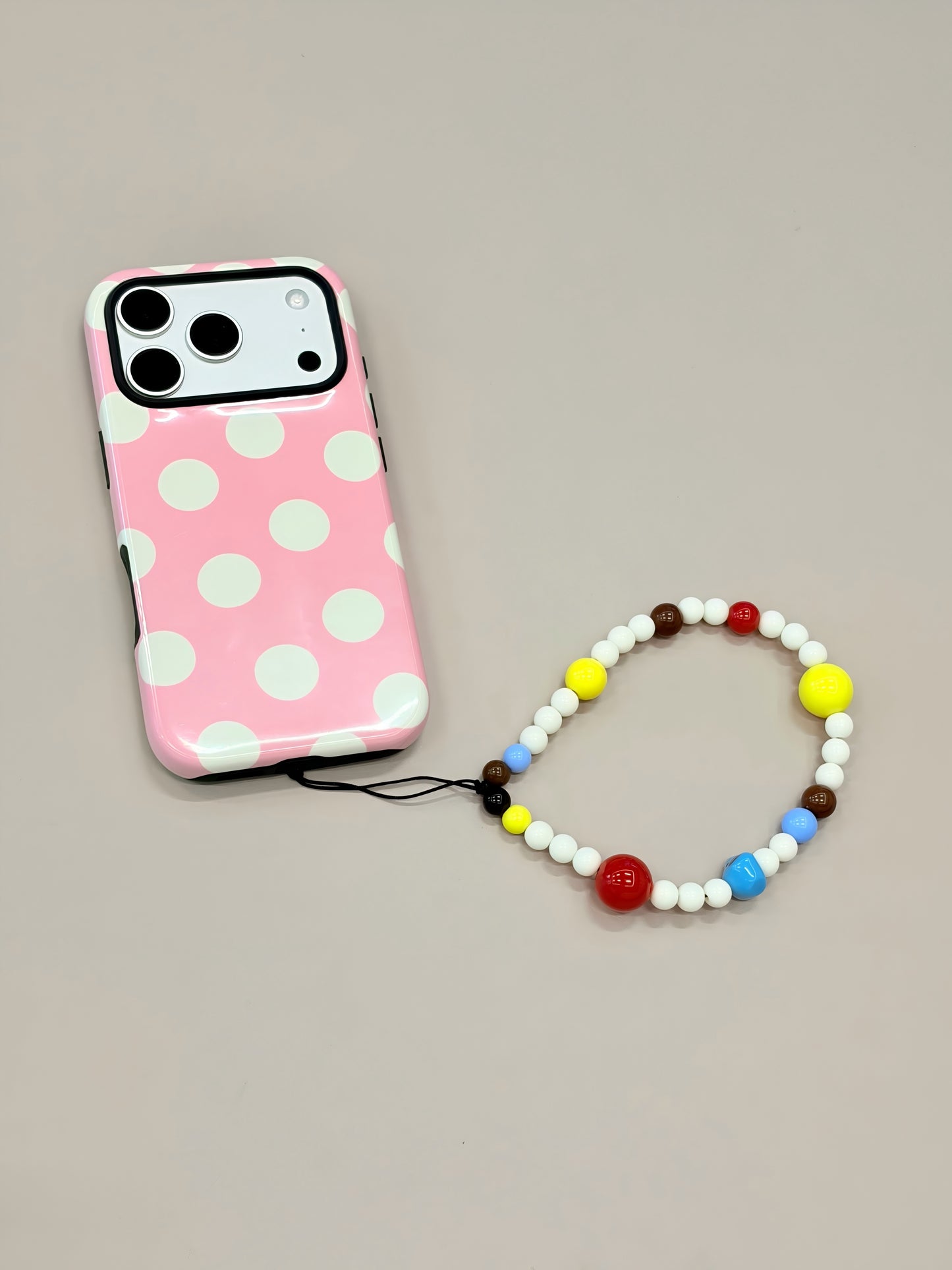 Beaded phone strap attached to mobile phone case