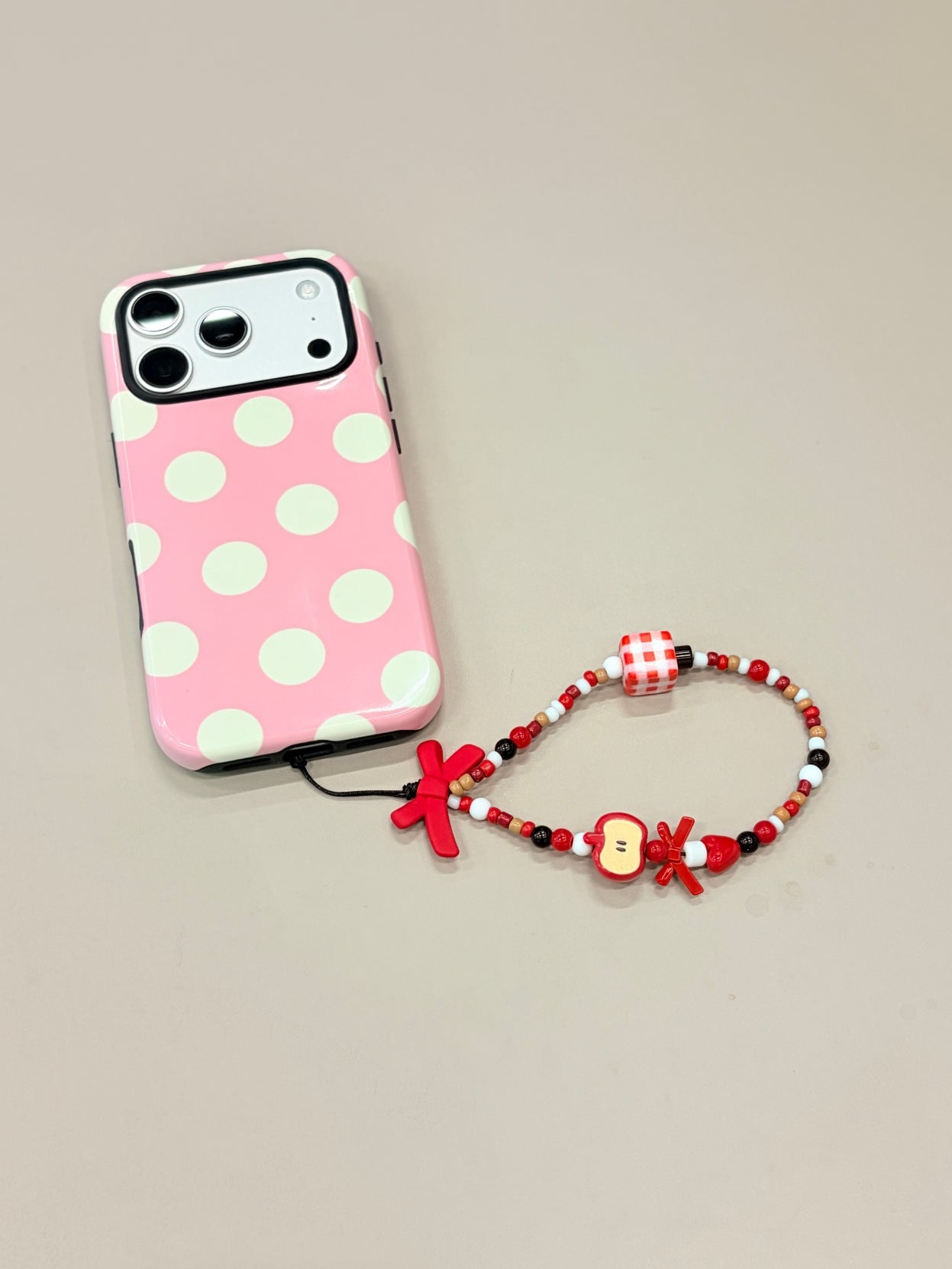 Bow beaded phone strap attached to mobile phone case