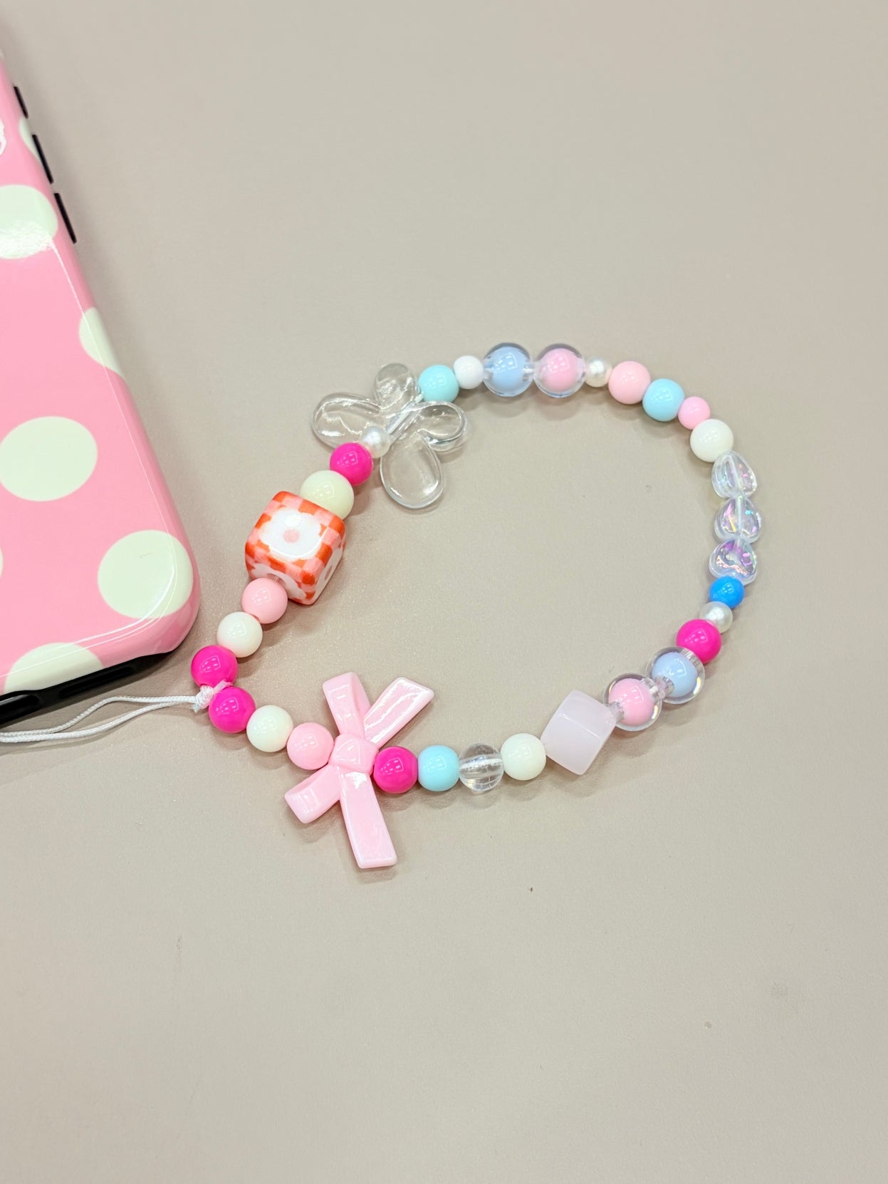 Close-up detail of butterfly charm phone strap