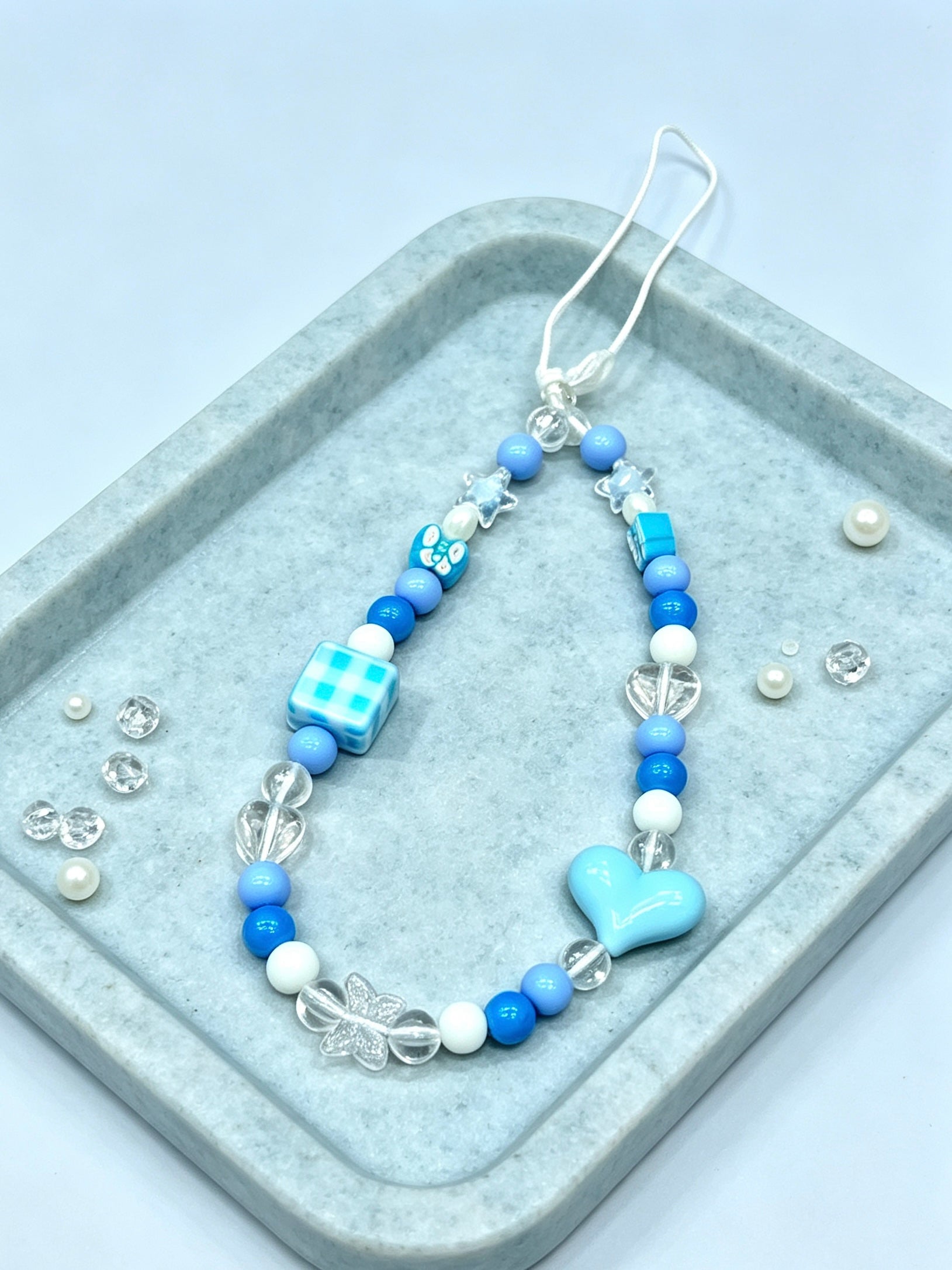 Close-up detail of heart bead phone strap accessory