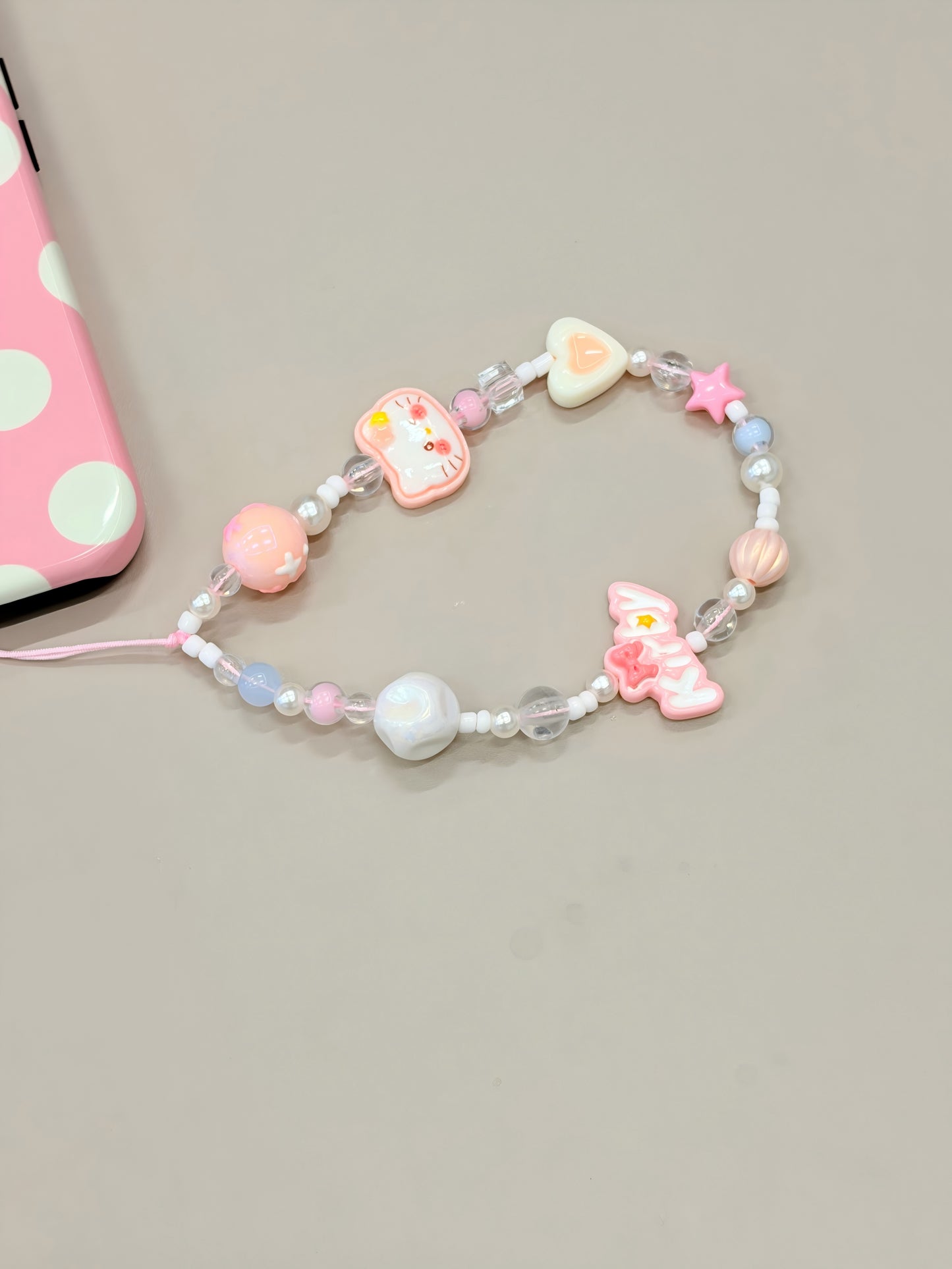 Close-up detail of heart butterfly bead phone strap