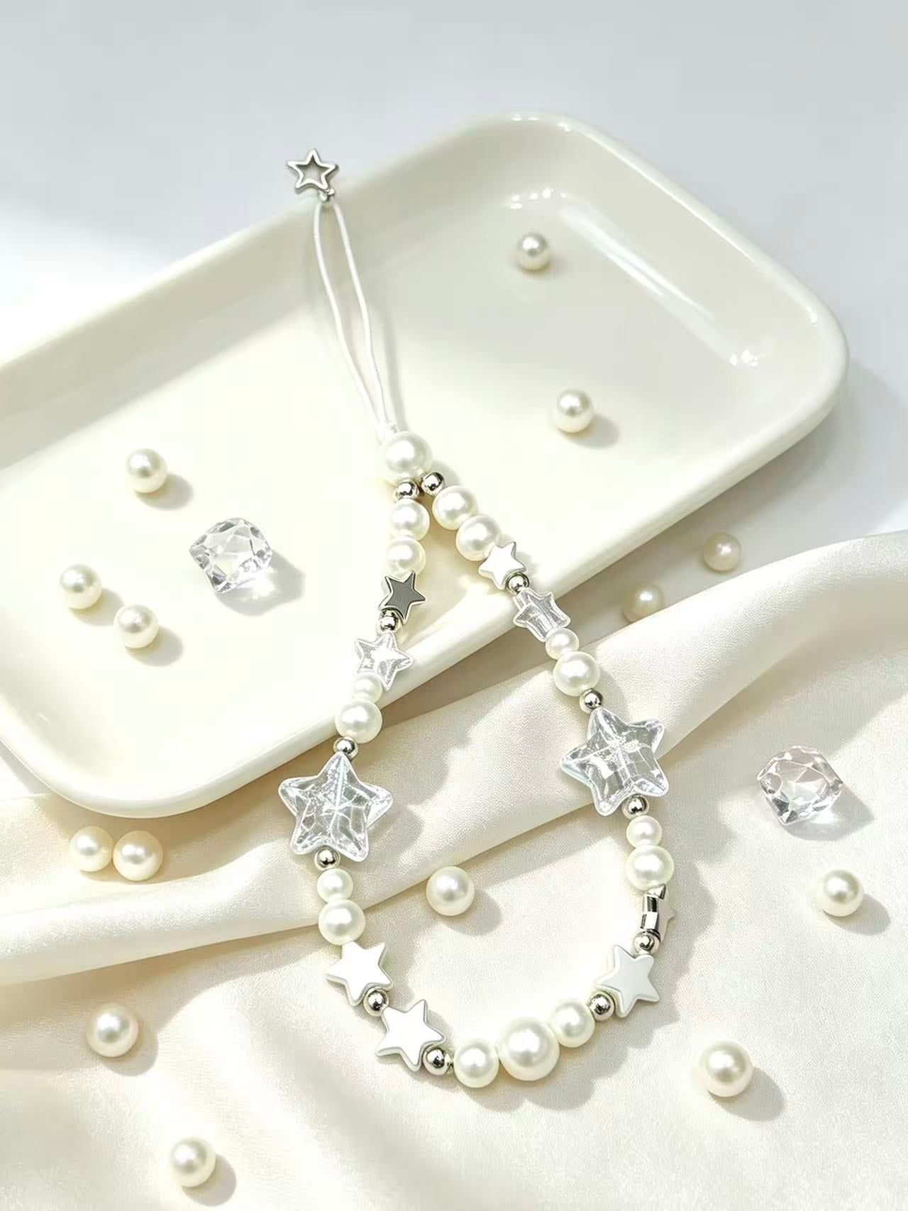 Close-up detail of pearl star phone strap accessory