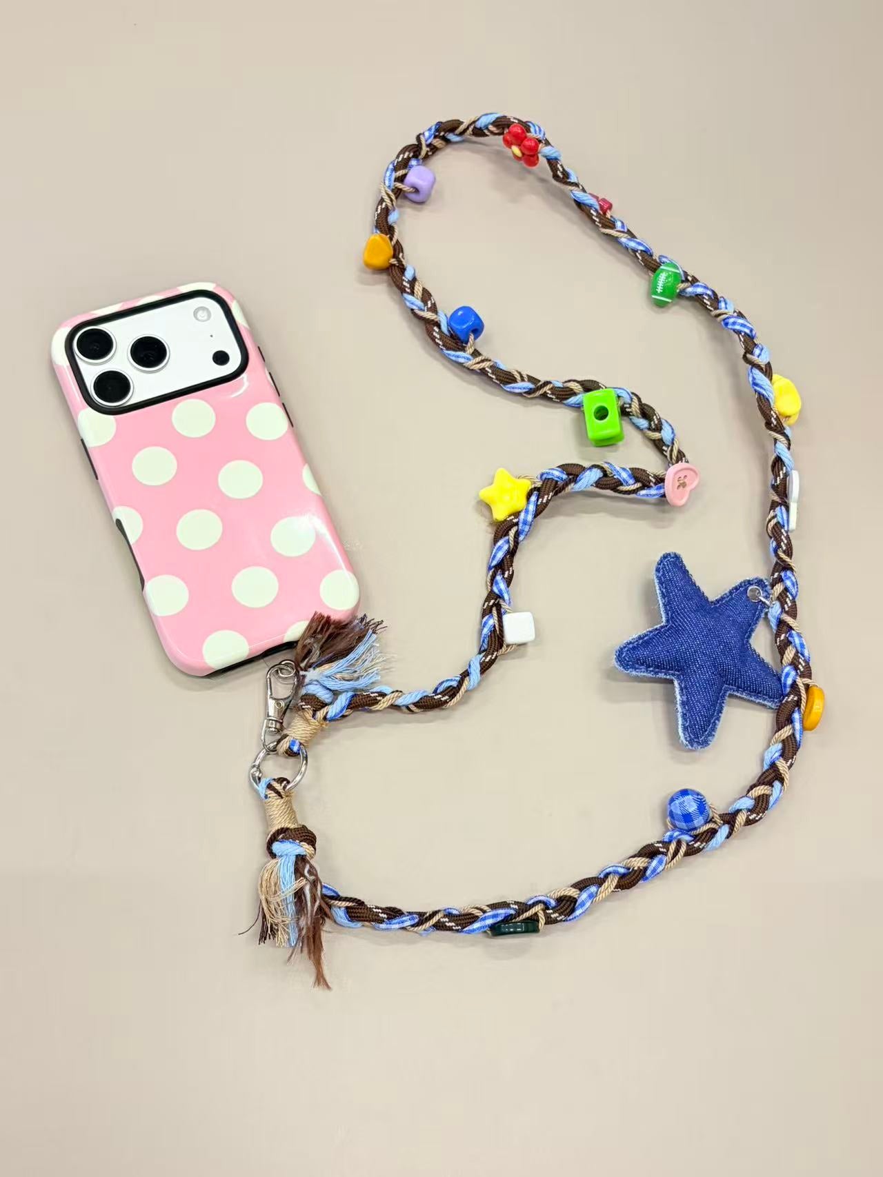Star beaded phone strap attached to mobile phone case